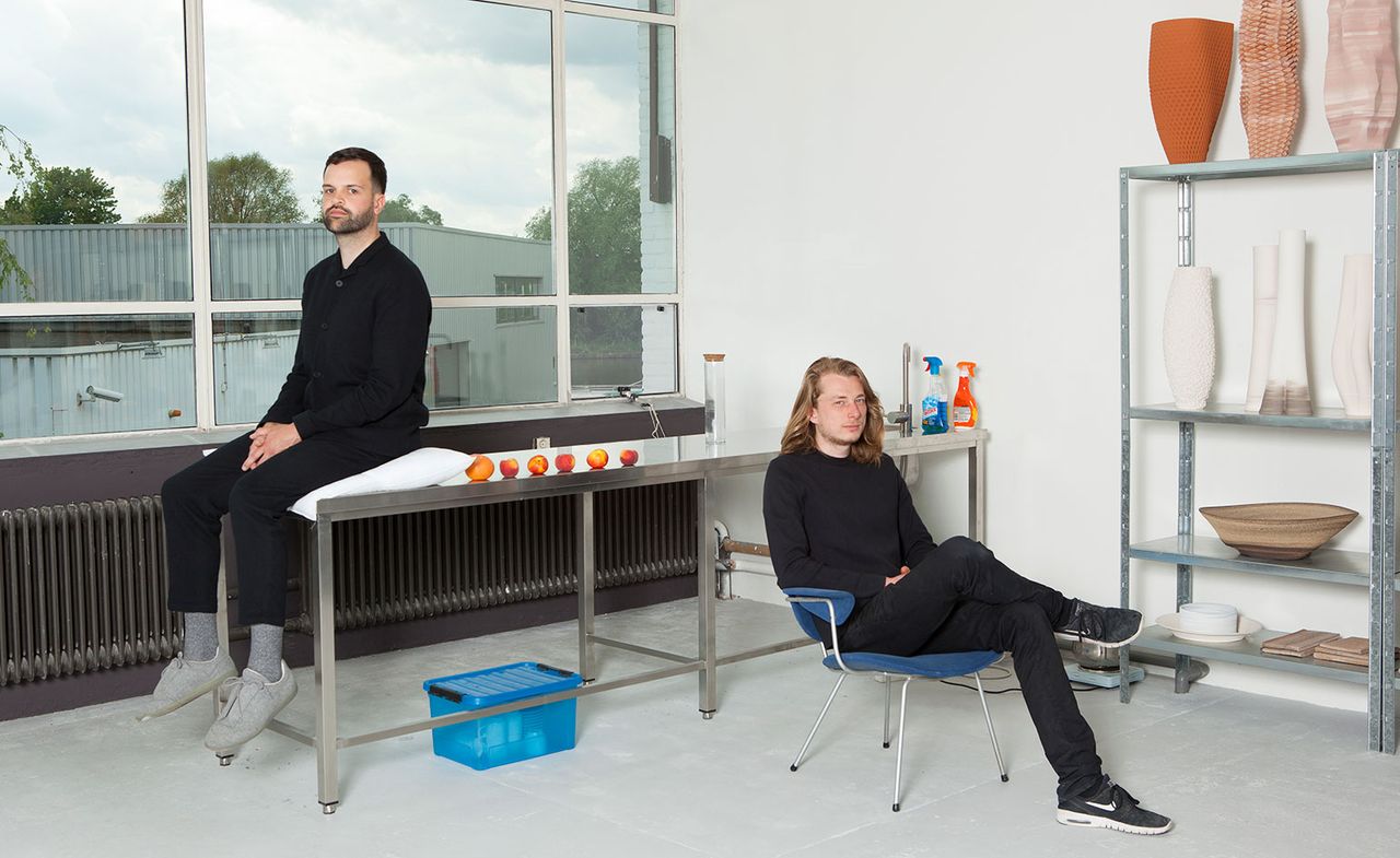 Tijmen Smeulders and Olivier van Herpt&#039;s Eindhoven studio, with some of his 3D-printed vases and bowls on display on the metal shelves.