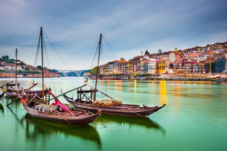 three boats on the water at Porto Portugal with city landscape in the background