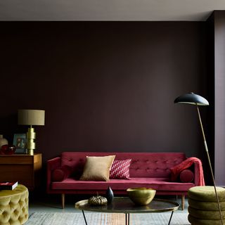 living area with black wall and red sofa
