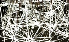 A closer look at the many white, neon lights and their cables. It resembles a neuron network.