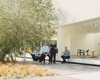 Giulia, Andrea, Carlo and Giovanni Molteni photographed at the Molteni Museum in Giussano with the brand’s ‘D.154.2’ chair, designed by Gio Ponti, and ‘Miss’ chair, designed by Afra and Tobia Scarpa