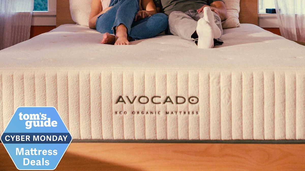 Foot of the Avocado Green Eco Organic Mattress with a pair of feet at the top, Tom&#039;s Guide Cyber Monday mattress deals badge in the lower left corner