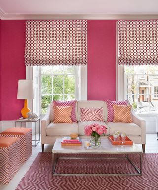 Pink living room with white floorboards and a patterned pink rug