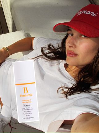 Hailey Bieber and a bottle of Universal C Skin Refiner by BeautyStat.