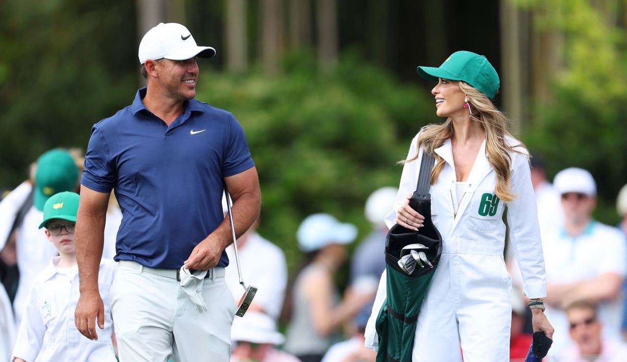 Brooks Koepka walks alongside his wife, Jena Sims, at the masters