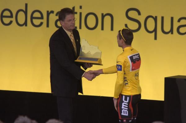 The Victorian Premier presents Evans with a trophy