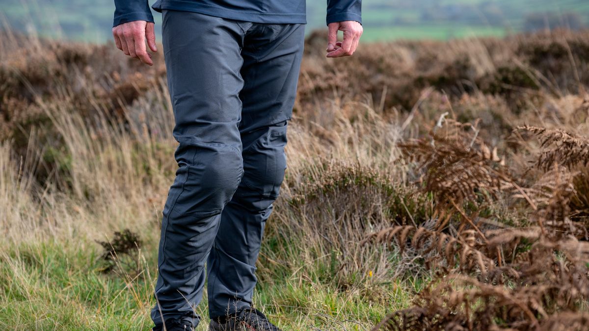 A male mountain standing while wearing 100% Airmatic pants one of the best mtb pants