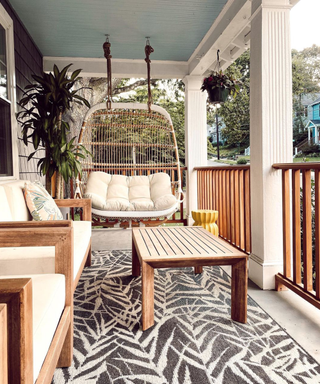 Front porch ideas by Laura Khesin with egg chair and wooden furniture