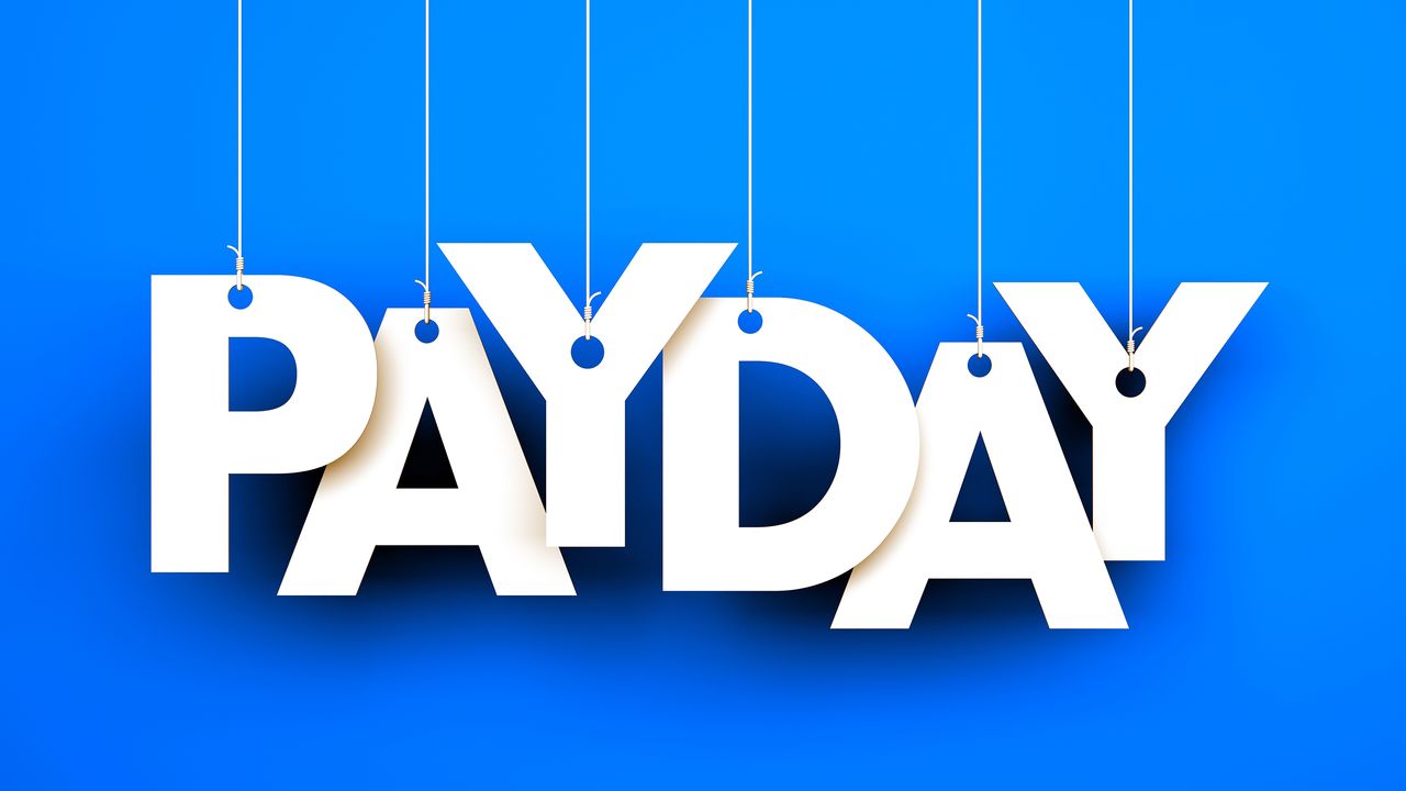 white letters spelling out PAYDAY hanging from strings with blue background