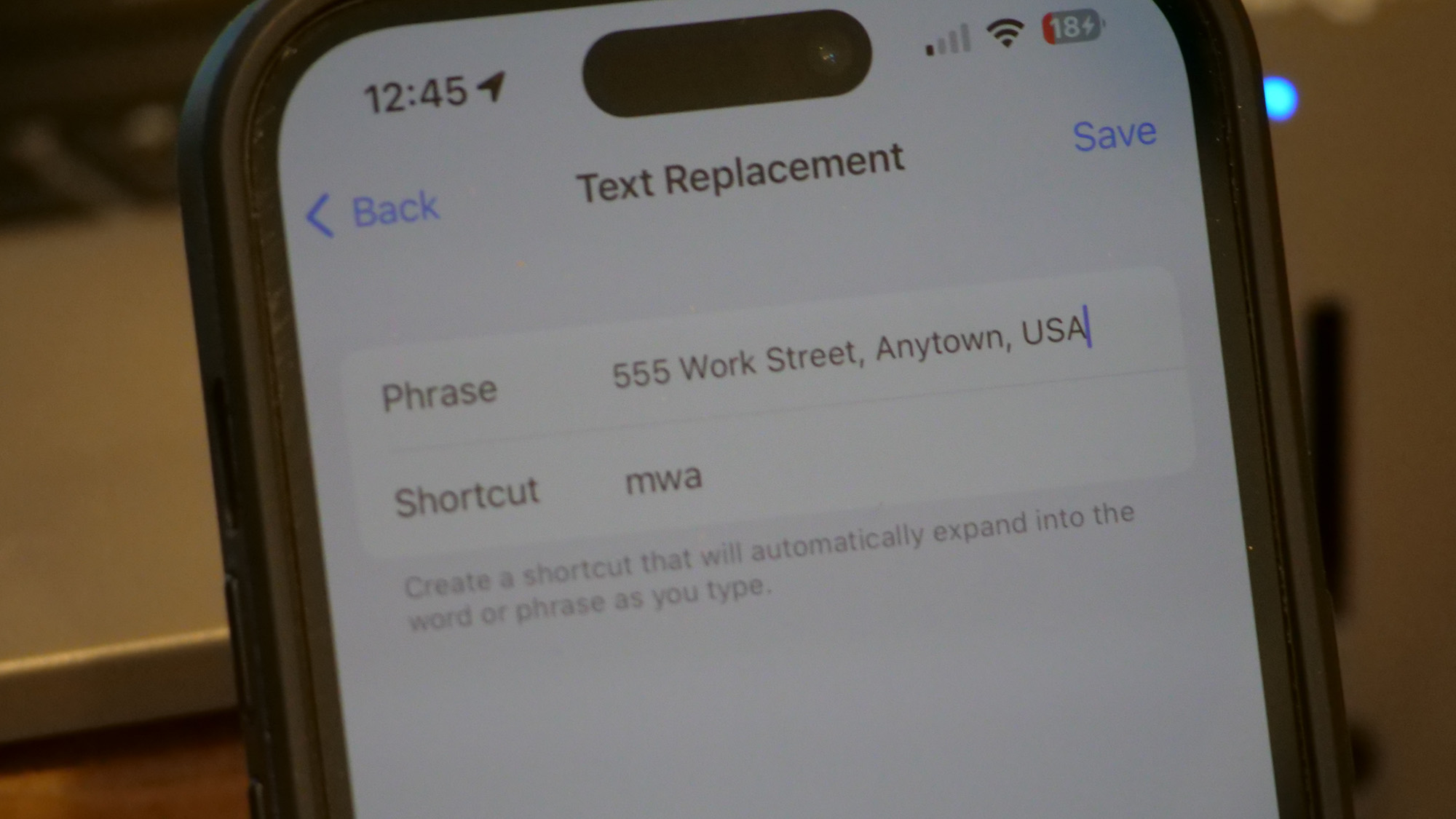 iPhone 14 Pro displays the Text Replacement in iOS to replace 