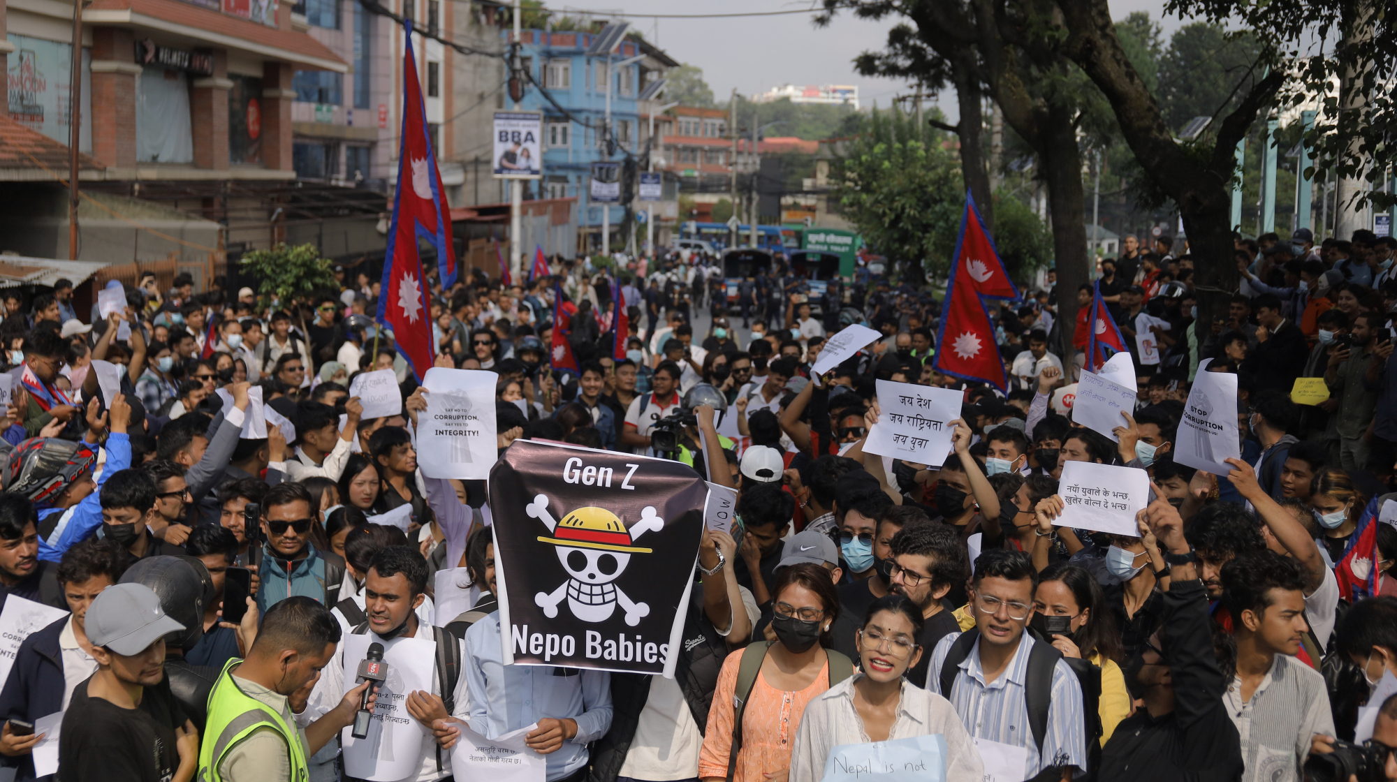A protestor displays a flag of an anime character symbolized as defiance during an anti-corruption and anti-social media ban protest in Kathmandu, Nepal, on September 8, 2025. The Gen Z protesters take to the streets against the corruption and the ban on social media platforms. Thousands of youths join the protests, criticizing rampant corruption and the government's ban on 26 unregistered social media platforms, including Facebook, Instagram, WhatsApp, YouTube, and Snapchat. 