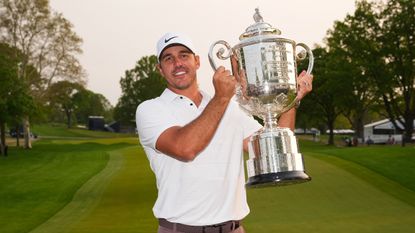 Brooks Koepka holds the Wanamaker Trophy