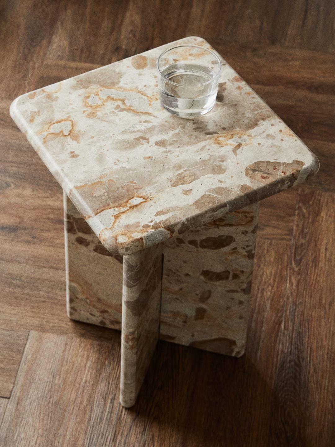 A round squared marble beige side table