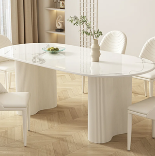 Minimalist white dining table with curved details from Wayfair.