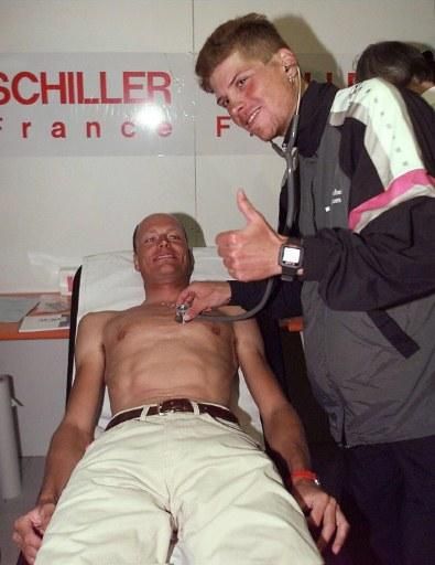Jan Ullrich checks over teammate Bjarne Riis