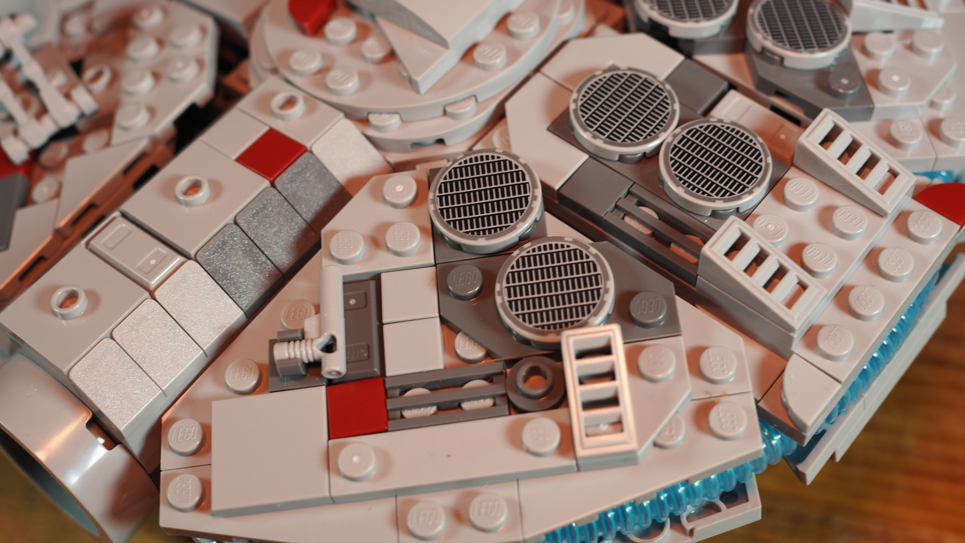 Lego Millennium Falcon set laid out on a wooden surface