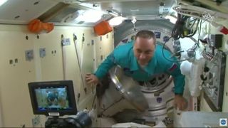 Soyuz MS-19 commander Anton Shkaplerov enters the International Space Station after docking on Oct. 5, 2021.