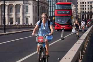 A cycling commuter in London on a Santander hire bike