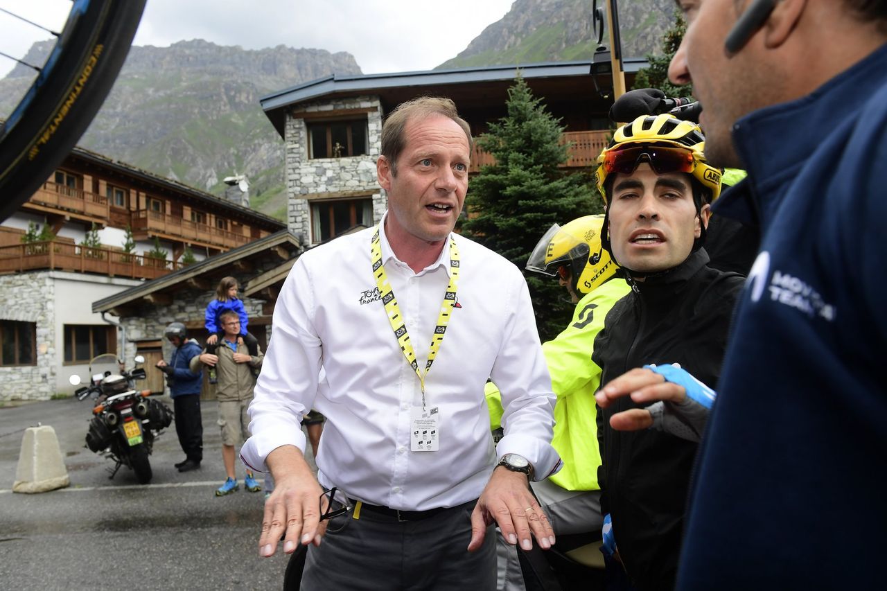 Tour de France race director Christian Prudhomme explains to Mikel Landa why the stage was shortened