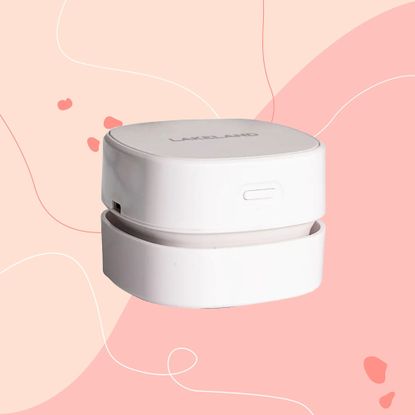 Lakeland mini countertop vacuum on a pink background