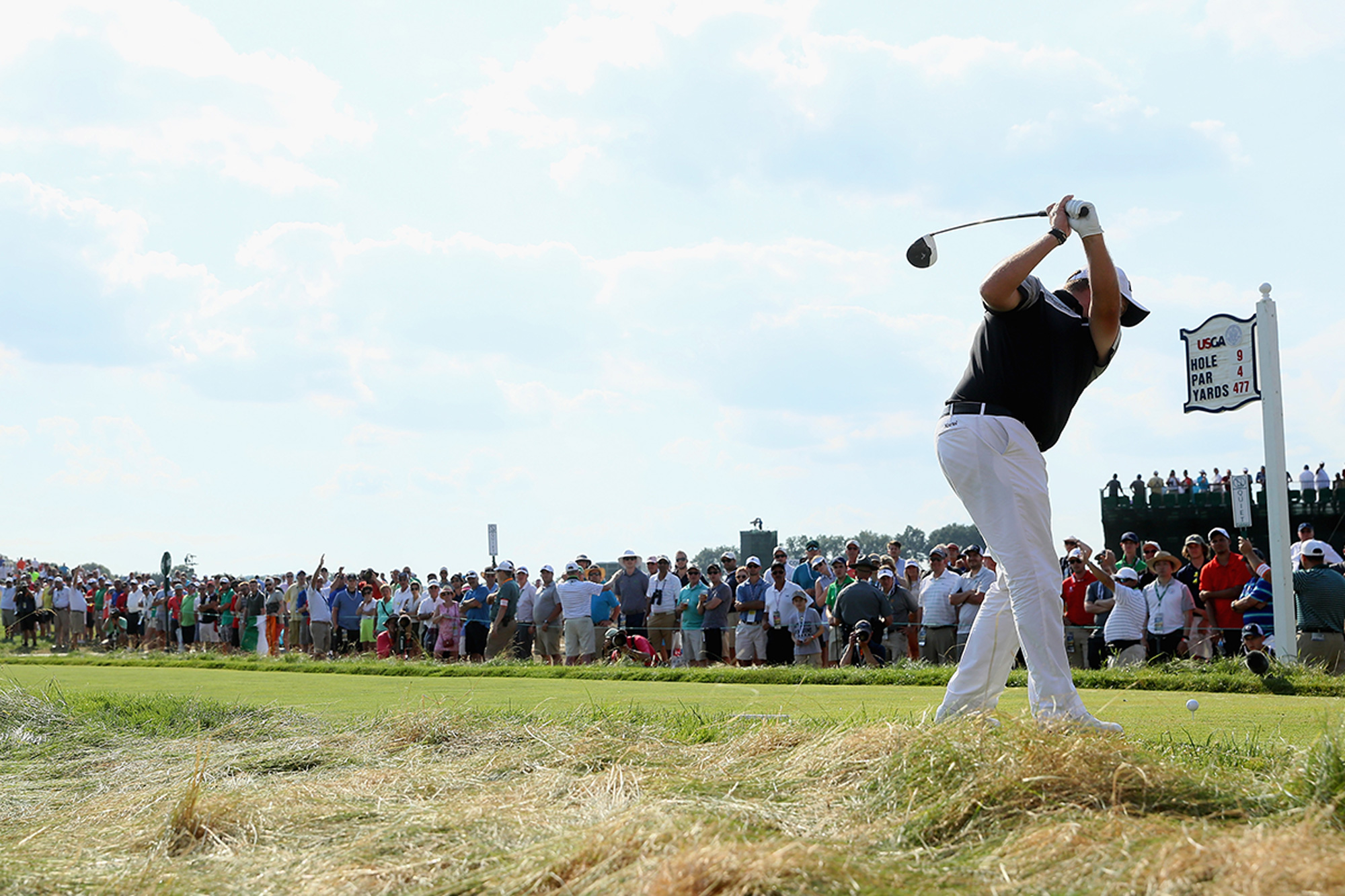 Shane Lowry at the top of his backswing in front of a gallery of fans, about to hit a tee shot on the 9th hole at Oakmont during the US Open