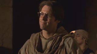 Daniel Jackson (Michael Shanks) speaks to a group of soldiers and smiles on Stargate SG-1.