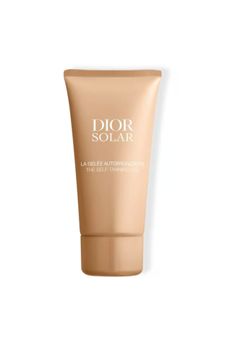 A golden-colored tube of Dior Solar self tanning gel against a white background.