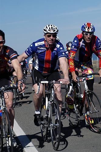 Greg LeMond keeps another rider at bay.