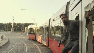 The Gray Man Ryan Gosling on train with gun
