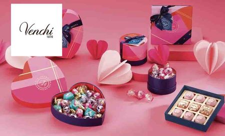 Venchi logo placed over an image of chocolates with pink bg 