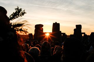 Crowds celebrating summer solstice and the dawn of the longest day of the year at Stonehenge on June 21, 2018 in Wiltshire, England