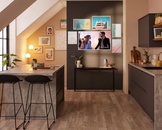 Samsung's The Frame in kitchen with console table, kitchen island and black bar stools