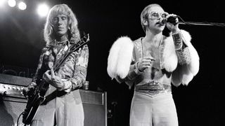 Davey Johnstone (left) and Elton John perform onstage circa 1974. 