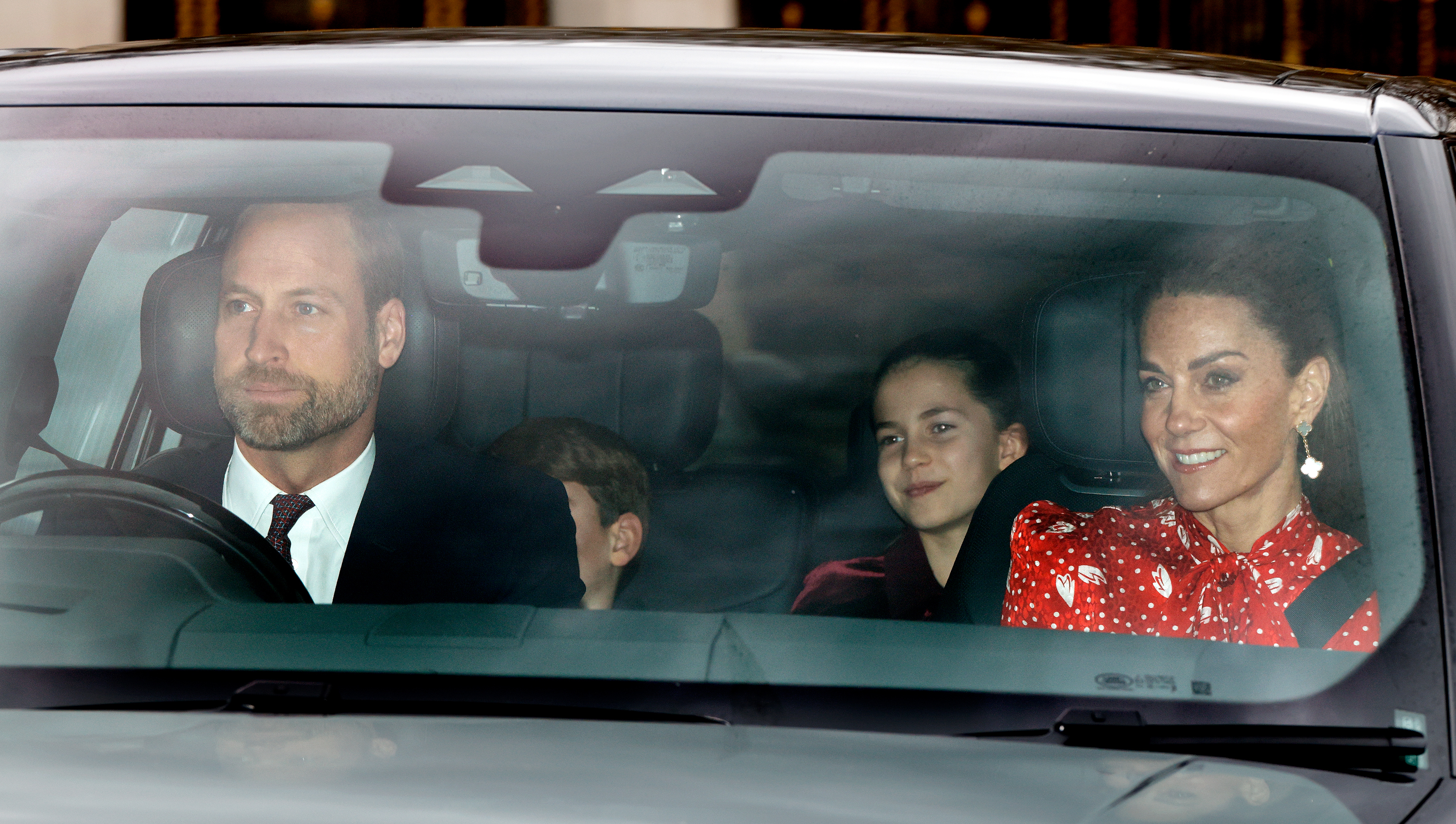 Prince William driving a car with Kate Middleton, Prince Louis and Princess Charlotte
