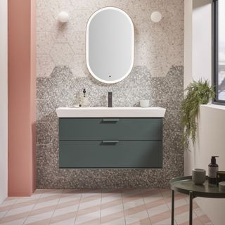 bathroom with mirror and green foliage