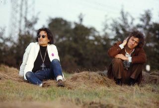 David Peel and American singer-songwriter Tim Buckley (1947-1975) sit on a grass verge in September 1968 in Germany.