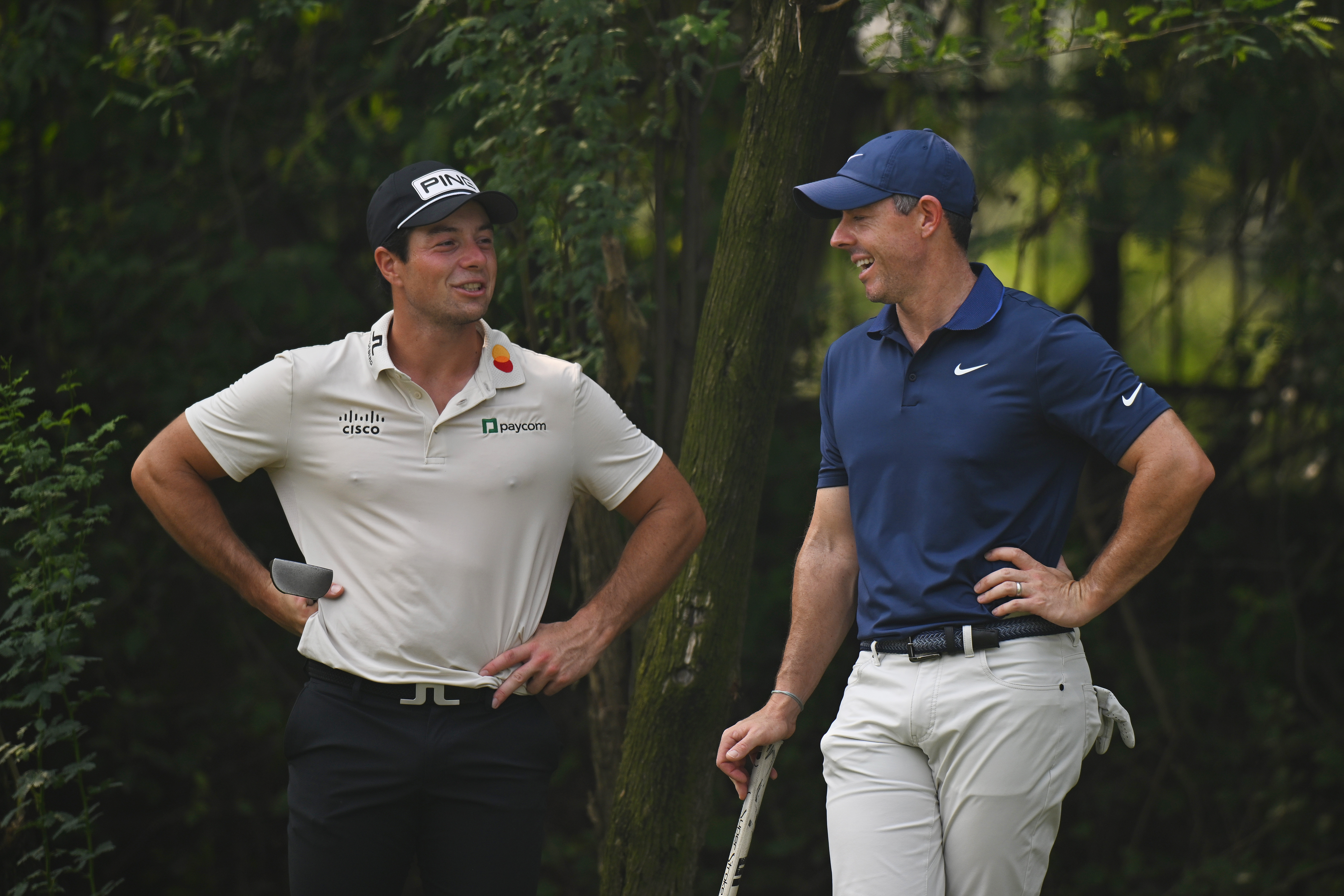 Viktor Hovland and Rory McIlroy chat on a tee box