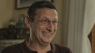 Ron making silly smiling face with in The Chair Company Episode 7