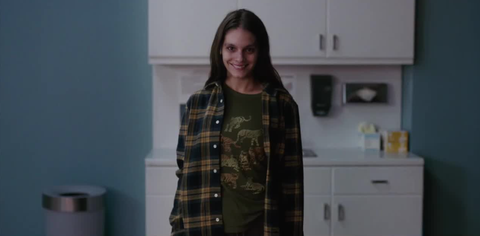 Smile star Caitlin Stasey as Laura Weaver, grinning at the camera