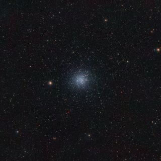 Super small sparkles are seen in this image of space. In the center, a slightly glowing section.