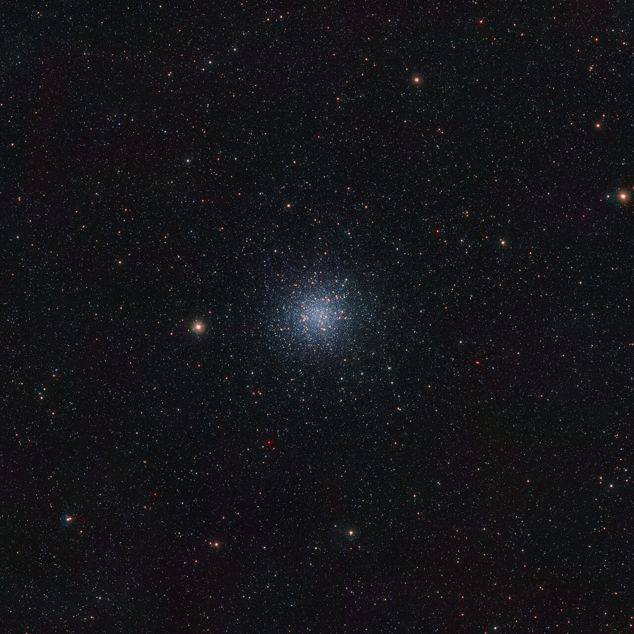 Super small sparkles are seen in this image of space. In the center, a slightly glowing section.