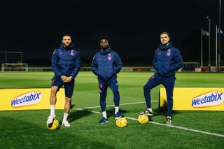Bukayo Saka, Jordan Henderson and Kyle Walker at St George’s Park for an exclusive training session with Weetabix prize winners.