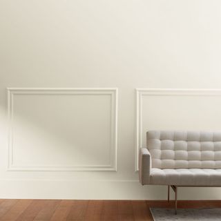 white paneled wall and neutral sofa