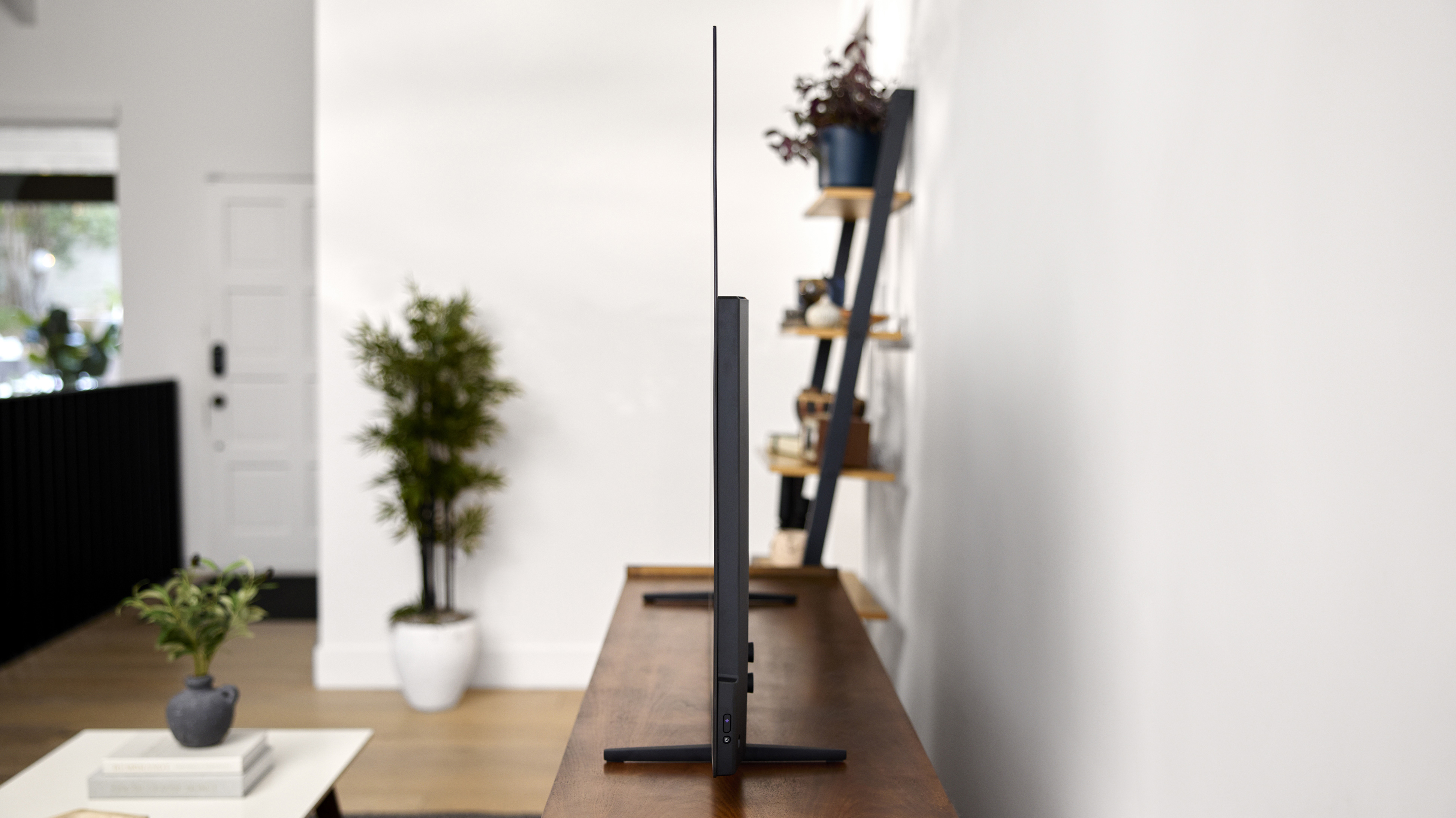 The Roku Pro Series OLED TV viewed from the side, showing its very thin profile