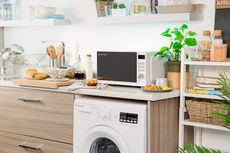 the Russell Hobbs Inspire Microwave Oven, one of the best microwave options, in a stylish modern kitchen with plants and accessories