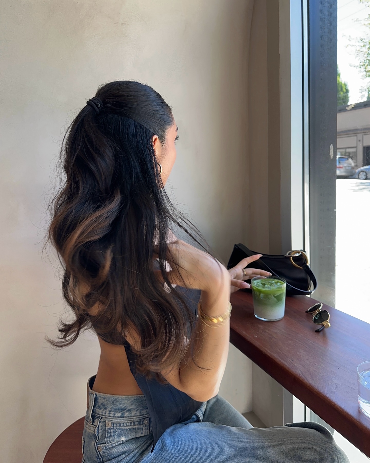 Mobina Peiman shows off her glossy, brown curls while wearing a blue tank top and jeans