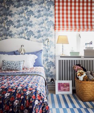 Blue and red child's bedroom with checked blind, floral wallpaper and striped rug