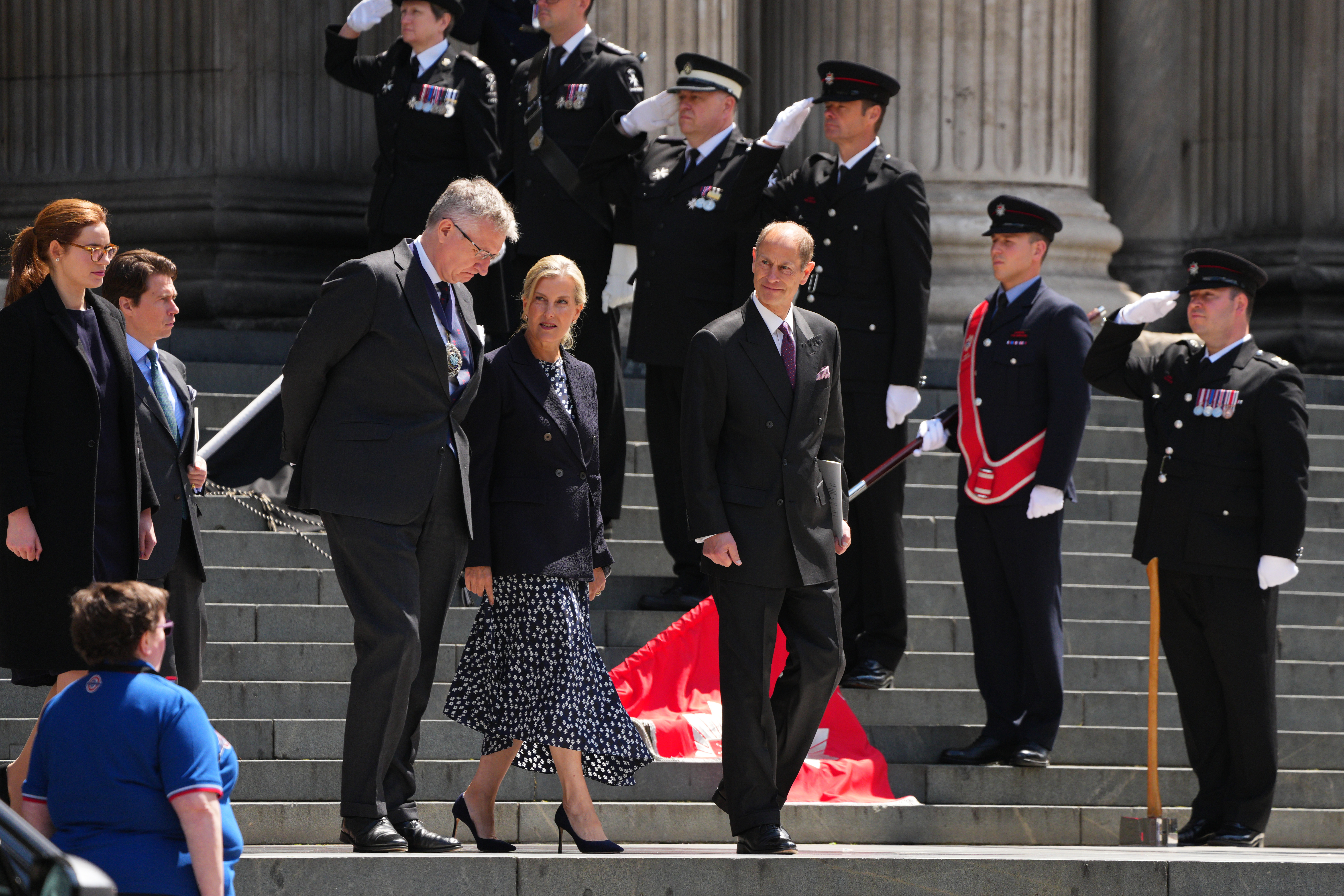 Duchess Sophie and Prince Edward leaving St. Paul's cathedral surrounded by soldiers
