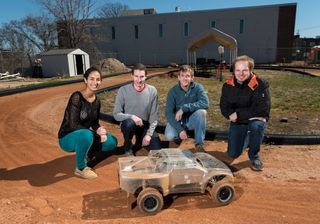 Georgia Tech researchers with one of the autonomous rally vehicles at the track. From left: Georgia Tech students Sarah Selim, Brian Goldfain, Paul Drews, and Grady Williams.