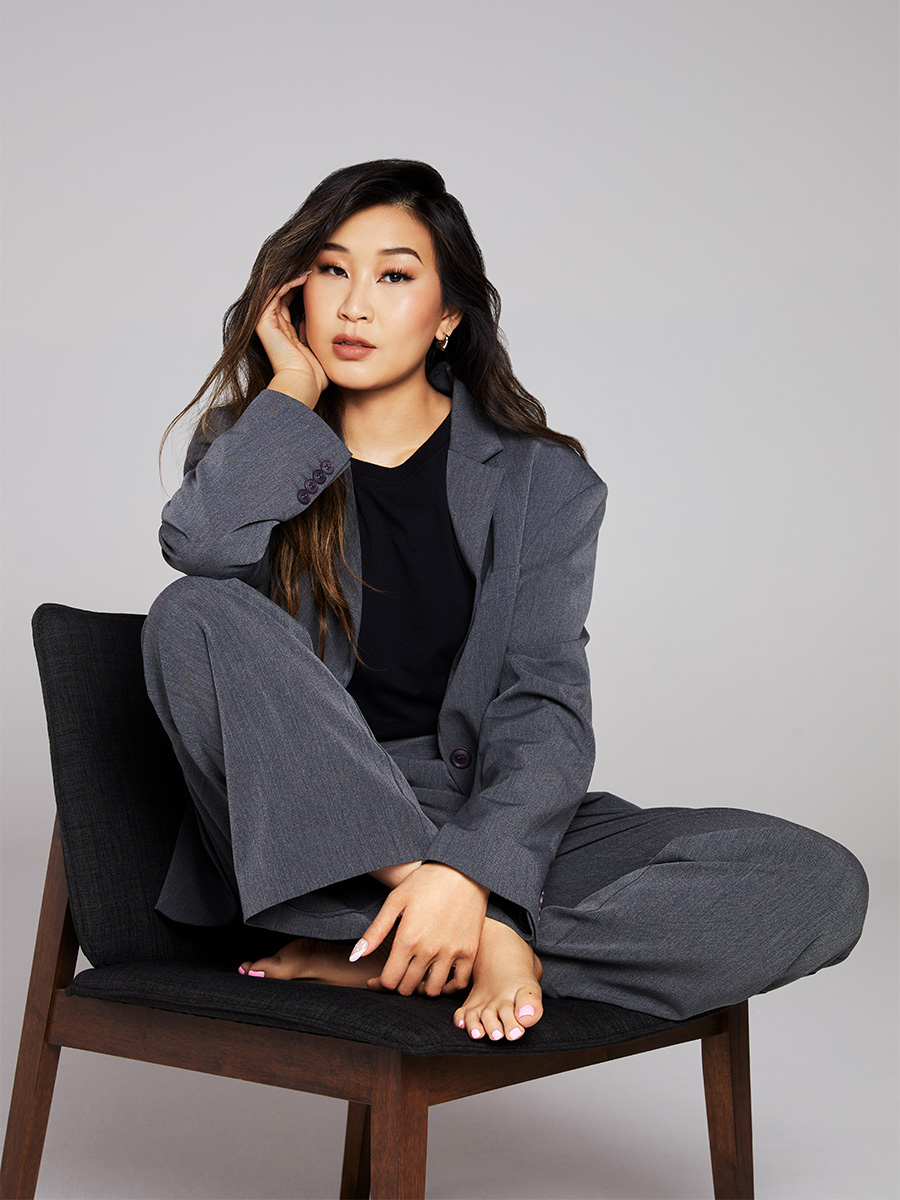 Pro racing driver Samantha Tan in a gray suit.